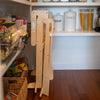 The Learn N Fold Learning Tower is folded up and stored in a kitchen pantry.