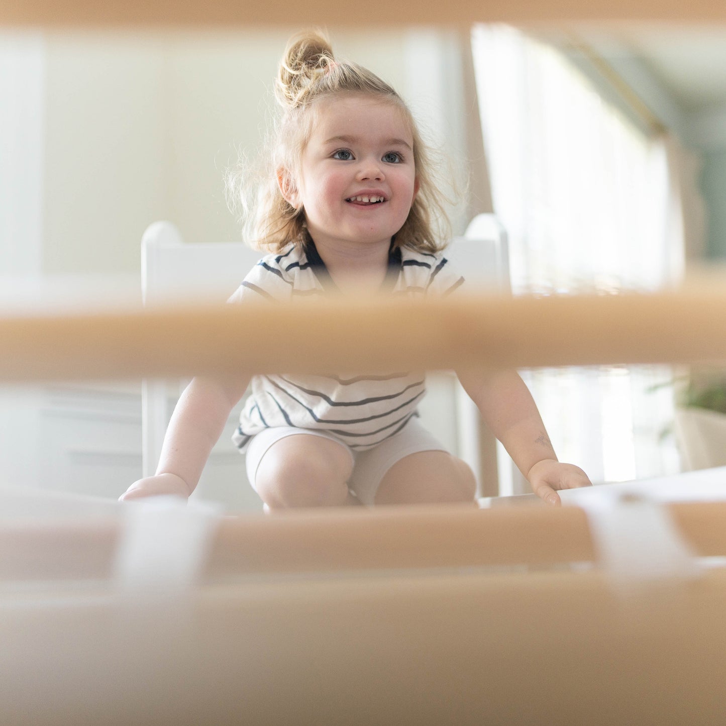 A young girl is climbing the Climbing Ladder.