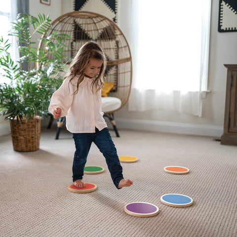 A young girl is walking on the Color Stepping Stones.