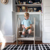 A boy is sitting on the 3-in-1 Growing Step Stool.  He is reading a book.