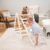 Two young girls are climbing on the Climbing Triangle and Climbing Ladder combination.